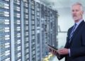 Portrait of senior businessman in big rack server room