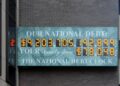 Cropped version US national debt clock / billboard. Picture was taken on April 19, 2008, so add approx. $1.5 billion per day to get current amount.