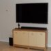 A modern flat-screen TV and soundbar in a living room, representing cable and streaming spending