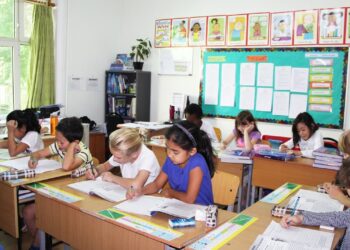 Modern elementary school classroom with students at their desks