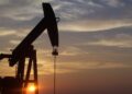A pumpjack silhouetted against the sunset in West Texas