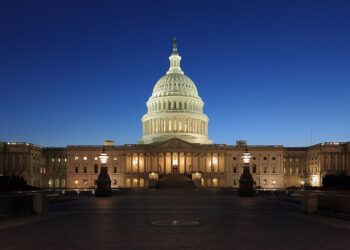 The U.S. Capitol at dusk, where Congress and the CBO shape federal deficit projections