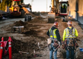 Construction workers standing at an active building site